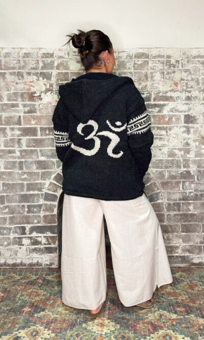 charcoal coloured woollen zip up jacket, with hood fleece lined with om symbol on back and stripe details